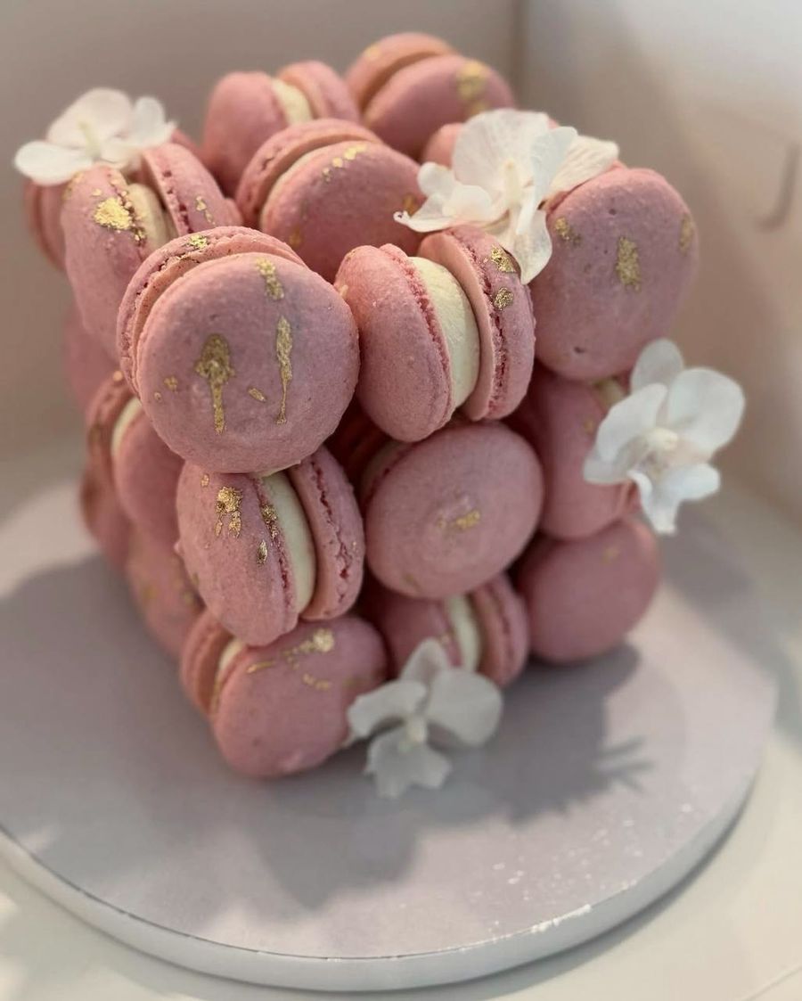Pink macaron cake with white flowers
